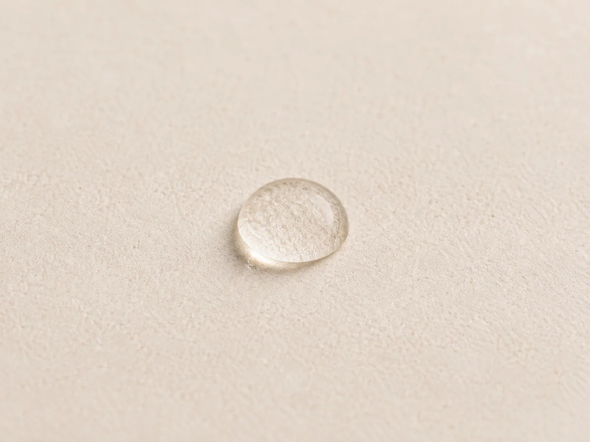A water droplet on a warm stone surface